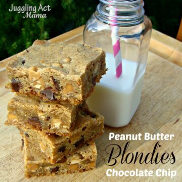 Close up image of peanut butter chocolate chip blondies sitting next to a glass of milk.