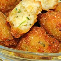 Zucchini Hushpuppies Recipe piled in a bowl for snacking.