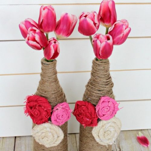 Upcycle your old wine bottles (or San Pelligrino bottles, in my case) into fun and festive bottle vases! Learn how to make these burlap rosettes to add some color, too!