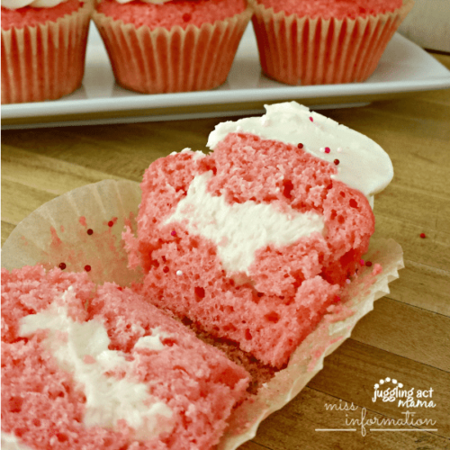 Close up image of a pink velvet cupcake cut in half.