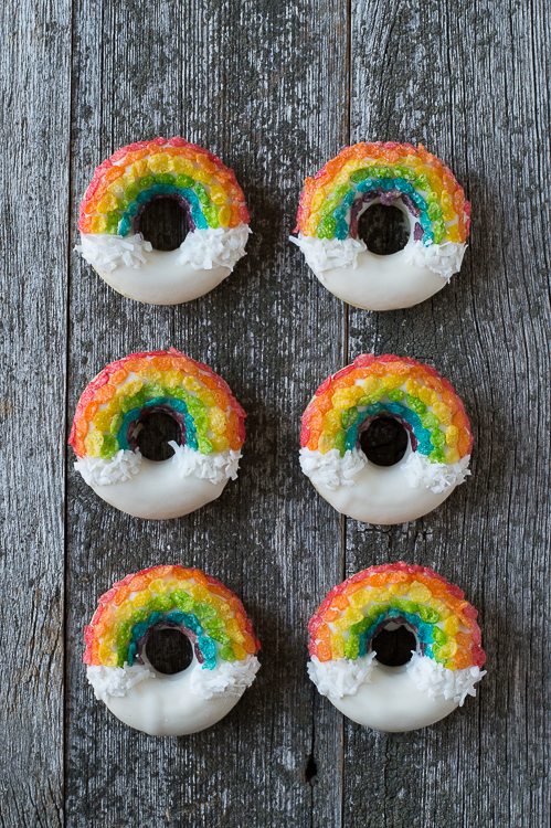 Rainbow Donuts on a wooden background.