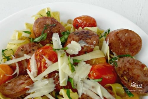 Close up of Italian Sausage and  Blistered Tomato Pasta with Parmesan Cheese.