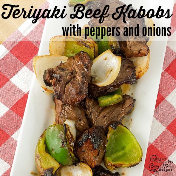 Teriyaki Beef Skewers with peppers and onions on white plate