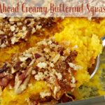 Butternut squash casserole with pecans on spoon.