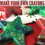 Close up image of star shaped molded crayons on top of Christmas fabric.