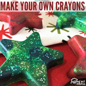 Close up image of star shaped molded crayons on top of Christmas fabric.