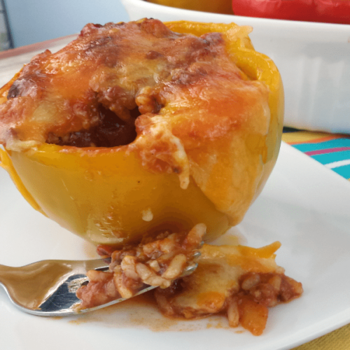 Chili stuffed peppers on a white plate.