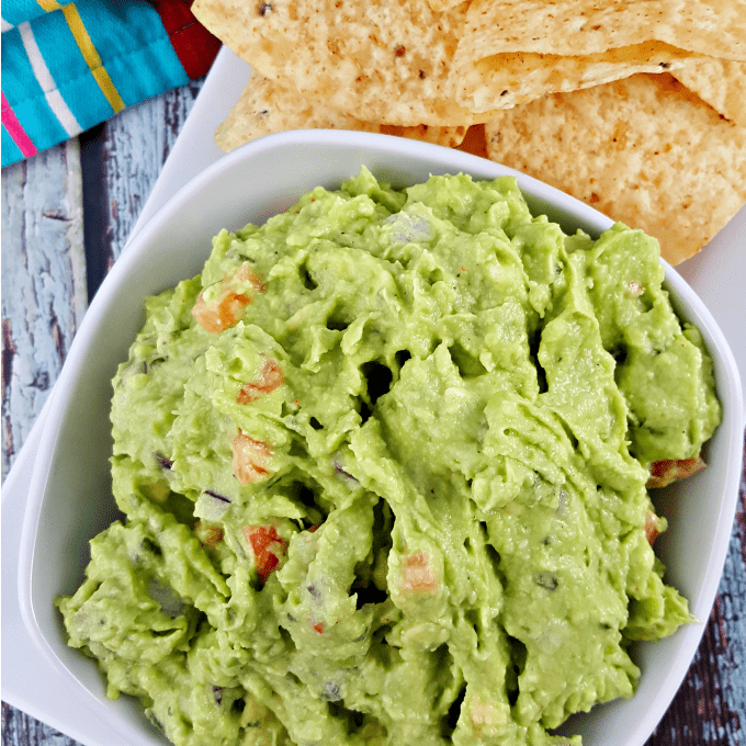 close up of homemade guacamole with chips