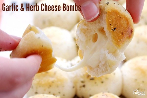 A woman pulling apart a garlic and herb cheese bomb.