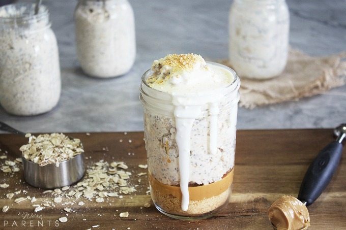A mason jar filled with Peanut Butter Cheesecake Overnight Oats from We're Parents.