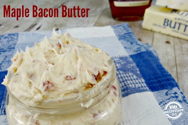 A small glass jar of maple bacon compound butter on a blue and white towel.
