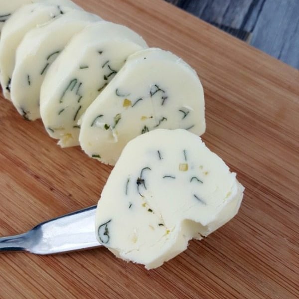 Close up image of sliced garlic basil compound butter.