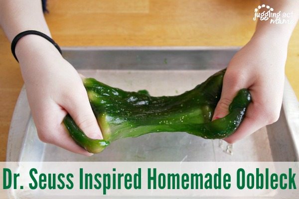 Children's hands pull apart homemade oobleck.