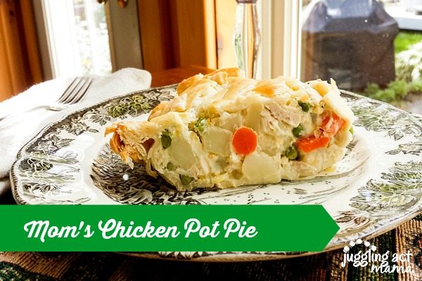 Horizontal image of a slice of mom's chicken pot pie on a plate with a fork and cloth napkin.