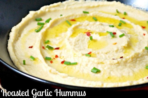 Close up of hummus garnished with green onions.