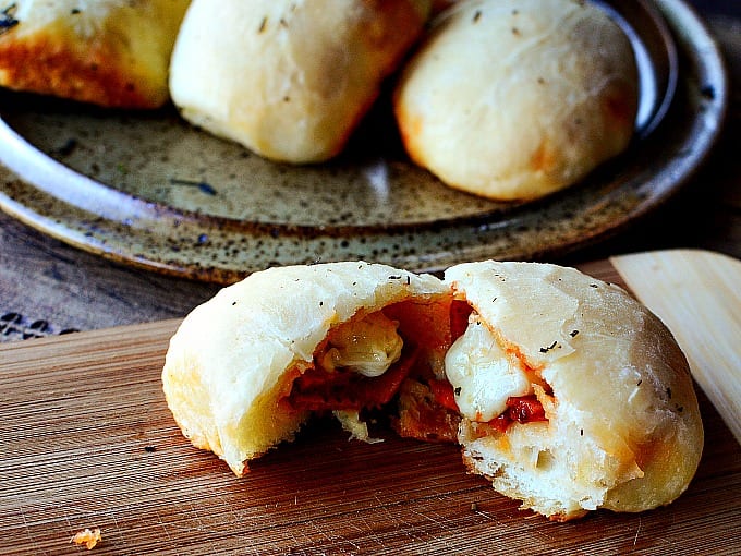 Close up of a stuffed pizza roll cut in two.