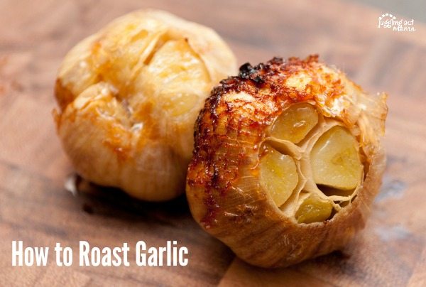 Close up of roasted garlic on a cutting board.