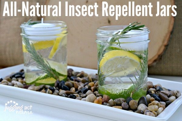 All Natural Insect Repellent Jars with rosemary, lemons, and floating candles.