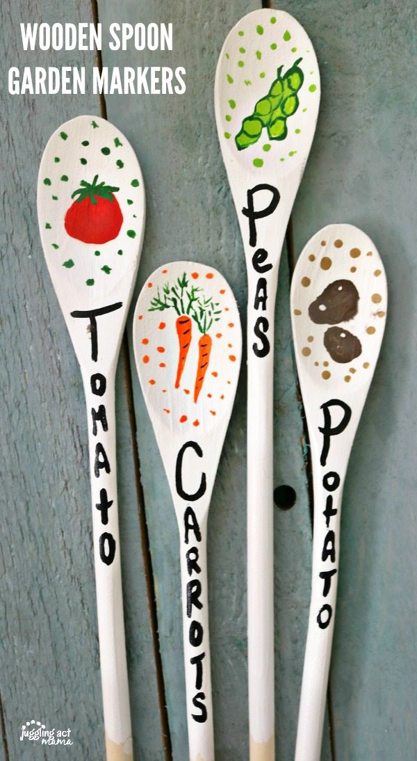 Close up of painted with potatoes, tomatoes, and carrots - Wooden Spoon Garden Markers.