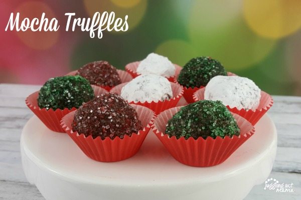 Pretty homemade mocha truffles on white platter. 