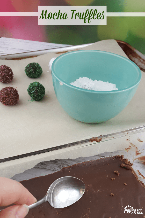 Pan with chocolate and spoon ready to roll into balls to make candy.