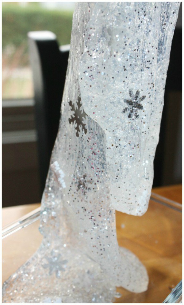 Close up image of snowflake slime in a glass dish.