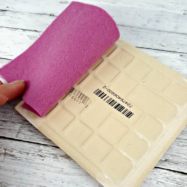 Cutting felt to size to fit on the backs of the marble coasters.