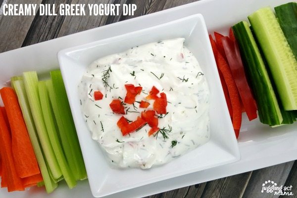 platter of vegetable sticks with easy Greek yogurt dip garnished with fresh dill and chopped red peppers