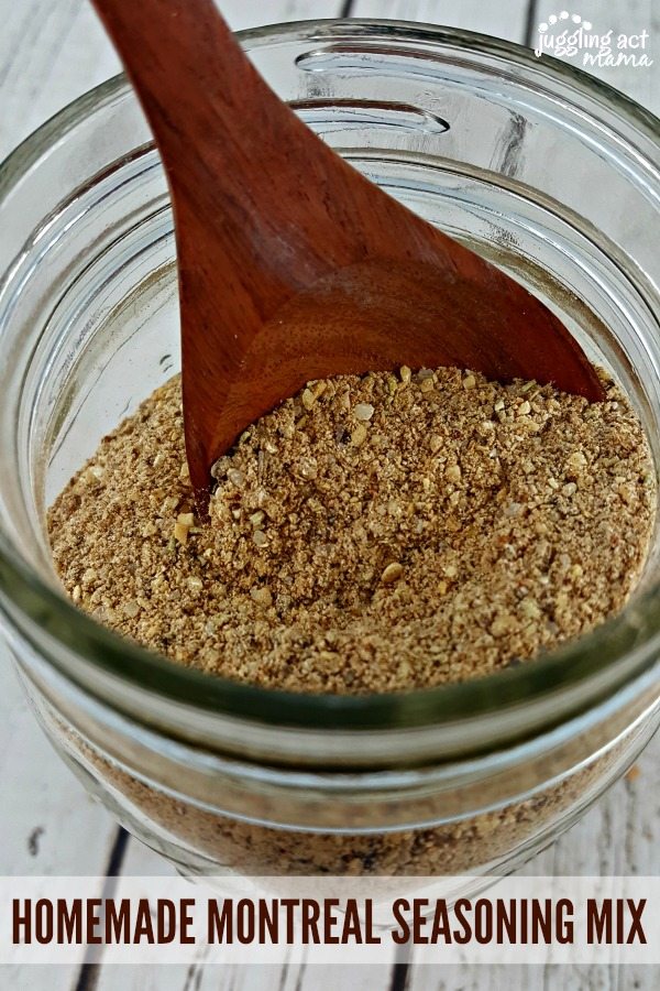 Homemade Montreal Chicken Seasoning in a glass mason jar with a wooden spoon.

