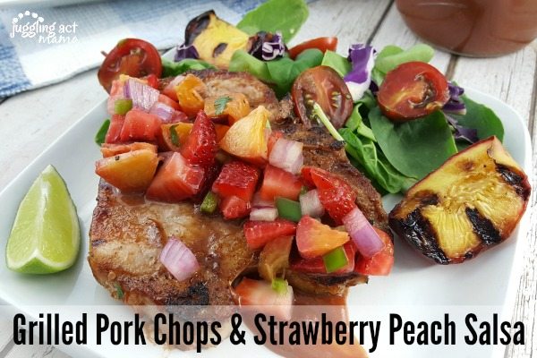 Grilled BBQ Pork Chops + Strawberry Peach Salsa on a white plate.