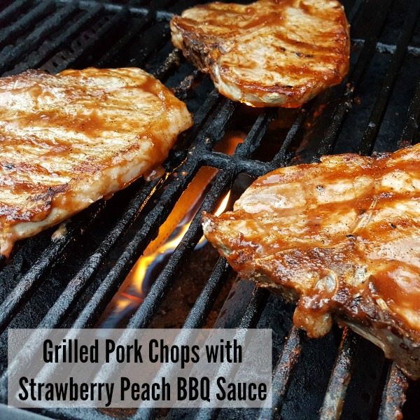 Grilled Pork Chops with Strawberry Peach BBQ sauce on a grill.