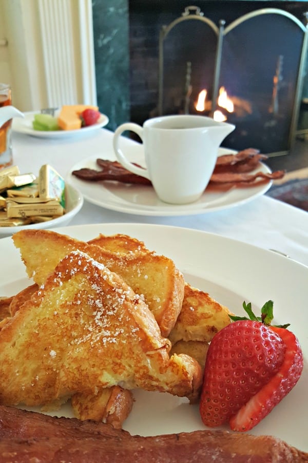 French toast and strawberries on a white plate.