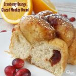Cranberry Orange Glazed Monkey Bread on a white plate.