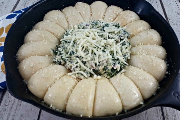 Topping it with cheese.