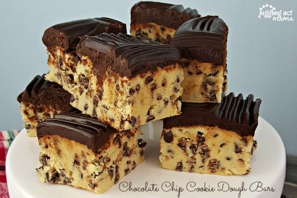 Chocolate Chip Cookie Dough Bars piled on a white cake plate.