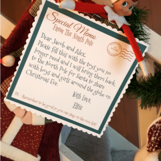 Elf holding a letter from the North Pole.