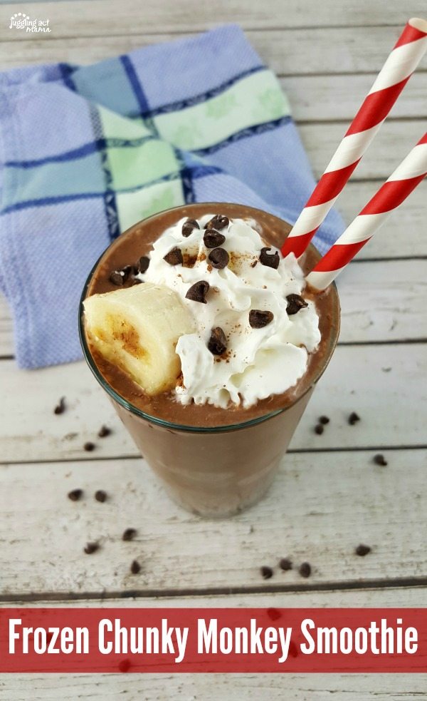 Chocolate Peanut Butter Banana Smoothie in a large glass with a straw and whipped cream.