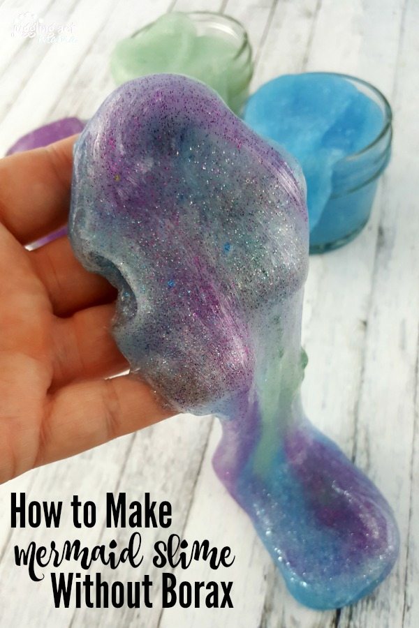 How to Make Mermaid-inspired DIY Slime Without Borax tutorial: a hand holds a mixture of blue, purple and seafoam green slime
