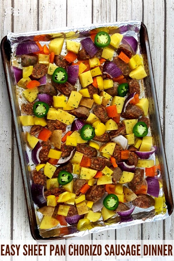 Top down view of a sheet pan with a chorizo sausage dinner on it.