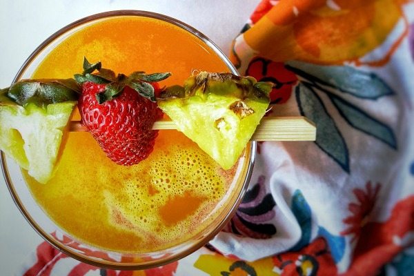 Top down view of Fruity Summer Pineapple Cocktail with pineapple and a strawberry.