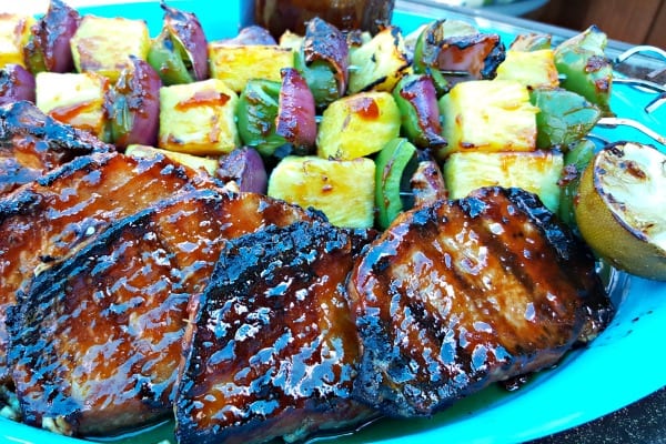 Pineapple Bourbon BBQ Grilled Boneless Pork Chops on a blue serving dish.