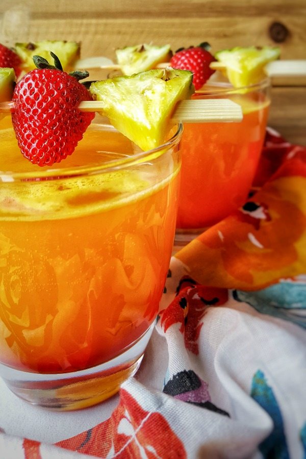 Summertime Pineapple Cocktails garnished with strawberries and pineapple.