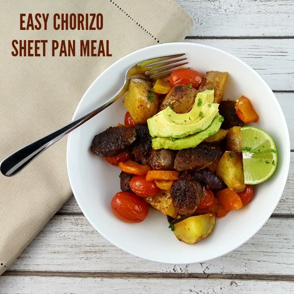 Top down image of meat and vegetables in a white bowl, topped with fresh avocado. 