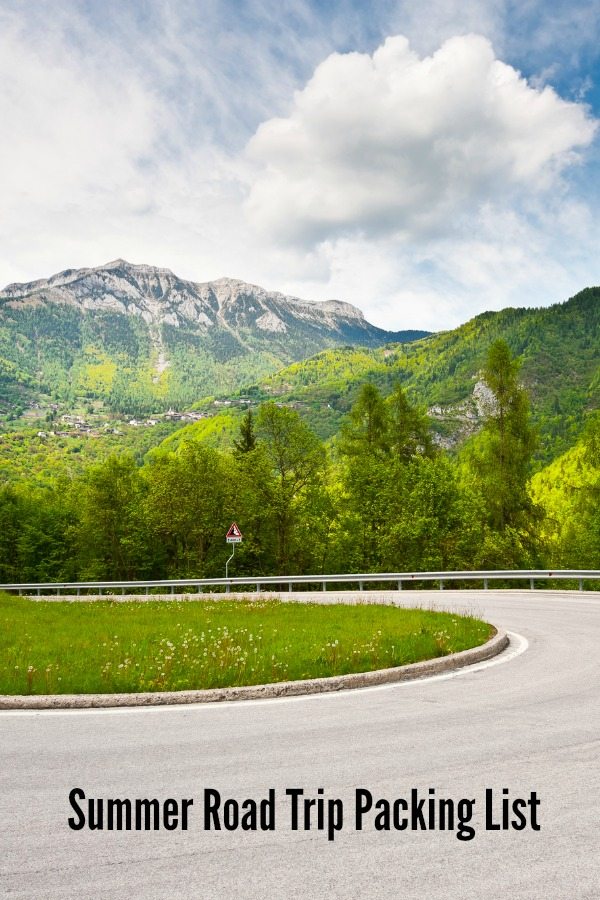 Mountain view next to a highway with Summer Road Trip List text overlay.
