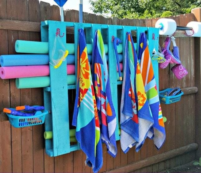 a palled painted teal and made into a pool storage for towels, noodles and other items.