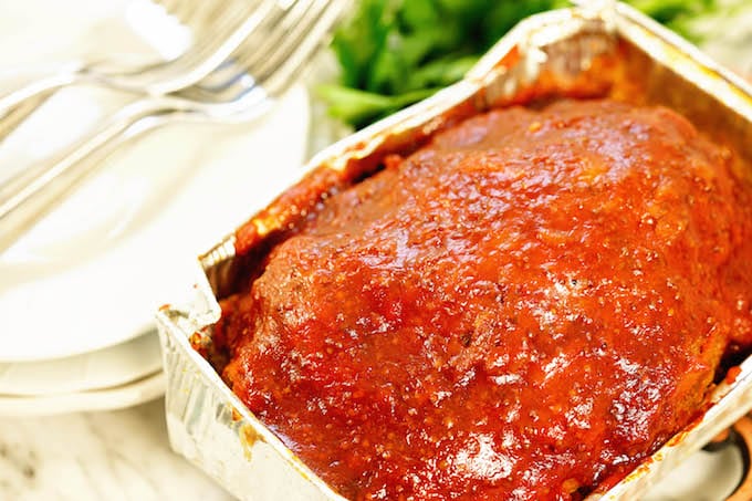 A small pan with meatloaf with a ketchup glaze