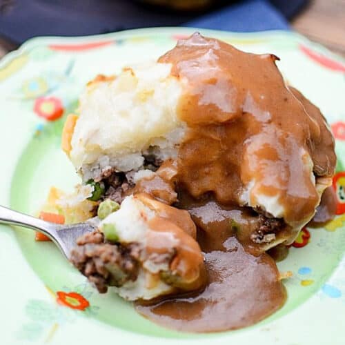 close up of Mini Shepherds Pie on a plate with a spoon