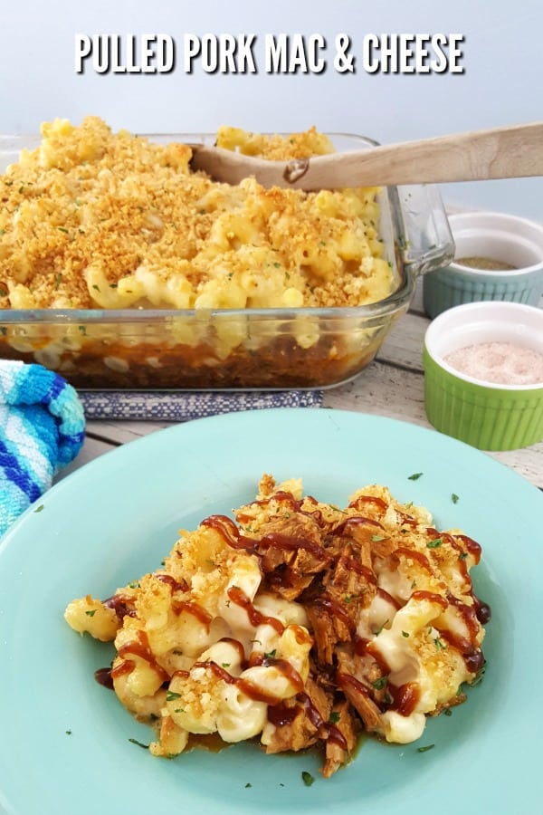 Pulled Pork Mac and Cheese on a light blue plate with a casserole dish in the background