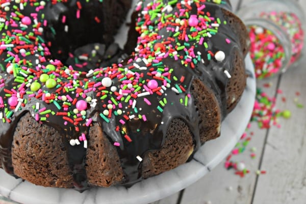 Chocolate bundt cake on white platter.