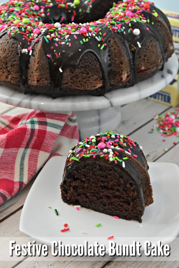 Slice of ganache and sprinkle covered chocolate bundt cake.